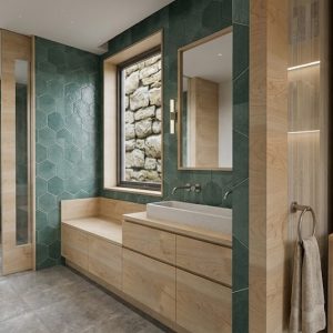 Vista panorámica de suite en ampliación de vivienda en Torrelodones, mostrando mueble de lectura con estantería retroiluminada de madera clara, paso hacia baño con alicatado hexagonal verde, mueble lavabo y ventana hacia muro de piedra, por Espacio Acorde.