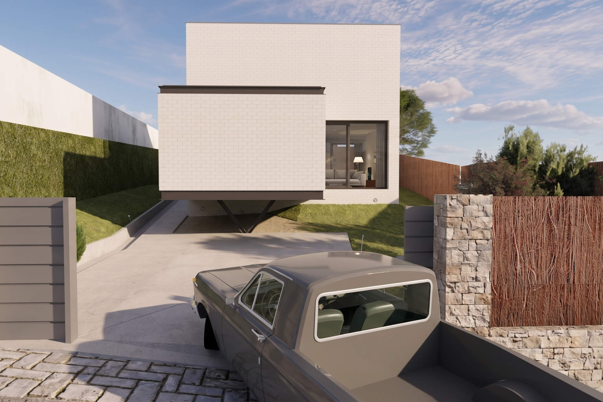 Fachada de monocapa blanca con volumen en voladizo, acceso rodado y cerramiento exterior de piedra en Las Rozas, Madrid.