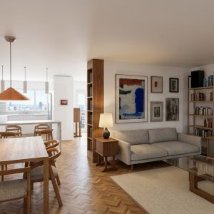 Vista panorámica del interior de una vivienda reformada en Alcalá Norte (Madrid), con zona de estar a la derecha provista de sofá gris y librería modular metálica, comedor central de madera y cocina blanca al fondo con iluminación natural, por Espacio Acorde.